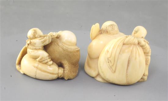 Two Japanese ivory netsuke of Hotei and a boy, Meiji period, width 4.1cm